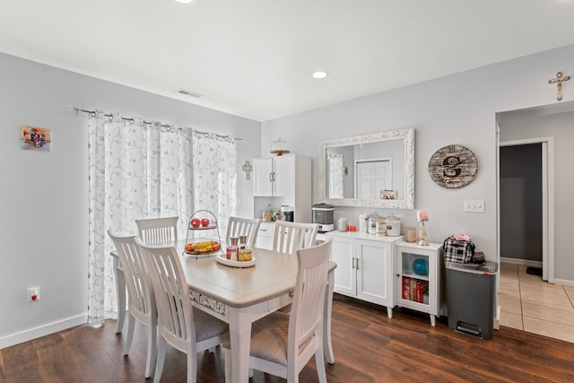 dining space featuring visible vents, baseboards, and dark wood-style flooring