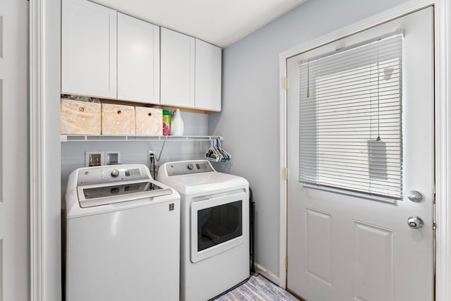 washroom with cabinet space and washing machine and clothes dryer