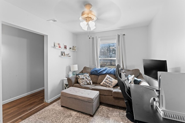 office area with visible vents, baseboards, wood finished floors, and a ceiling fan