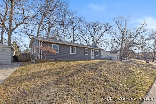 ranch-style house with a front yard and fence