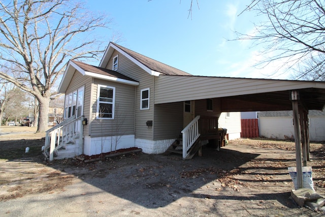 view of home's exterior featuring a carport and entry steps