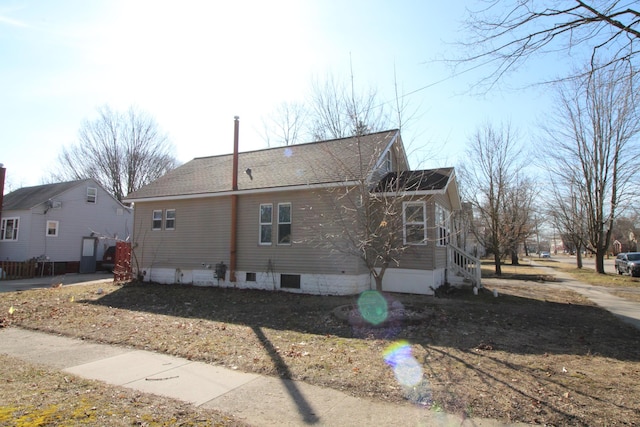 view of home's exterior featuring roof with shingles