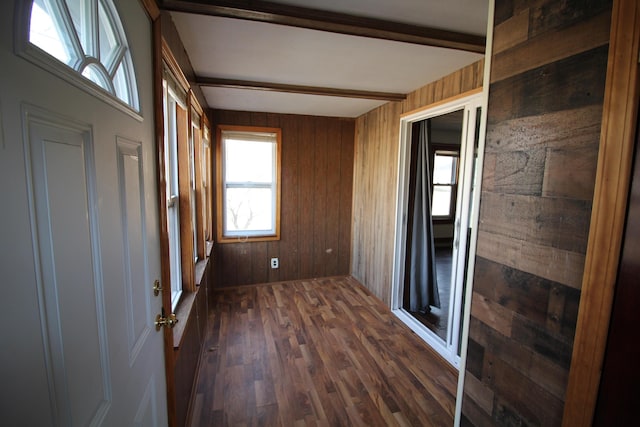 unfurnished sunroom featuring beam ceiling