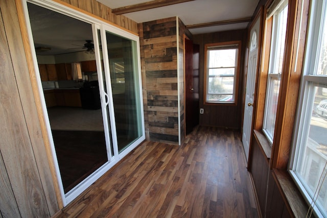 unfurnished sunroom featuring a ceiling fan