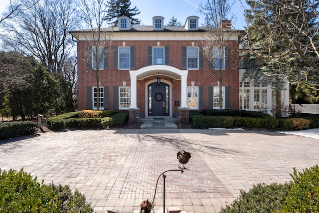 colonial home with brick siding