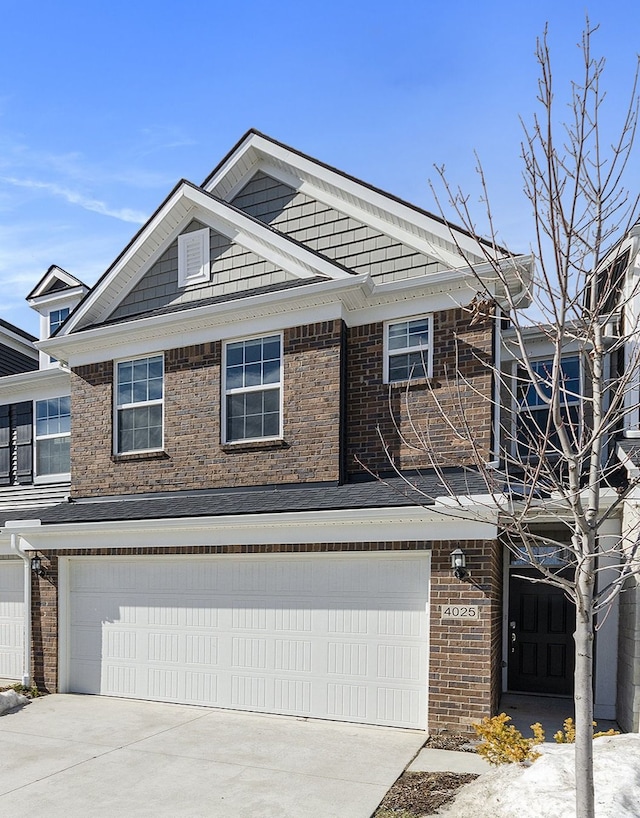 view of front facade with a garage, brick siding, and concrete driveway