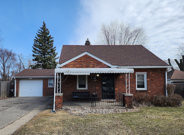 bungalow-style home featuring brick siding, a shingled roof, fence, a garage, and driveway