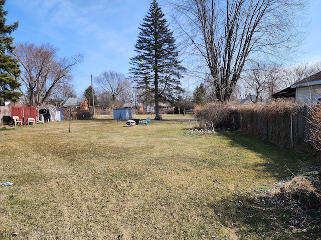 view of yard with a storage unit and an outbuilding