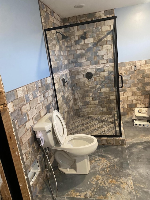 bathroom with toilet and a stall shower