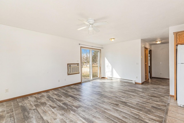 empty room featuring a ceiling fan, baseboards, a wall mounted AC, light wood-style flooring, and baseboard heating