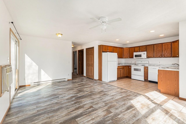 kitchen featuring a baseboard heating unit, ceiling fan, light countertops, brown cabinetry, and white appliances