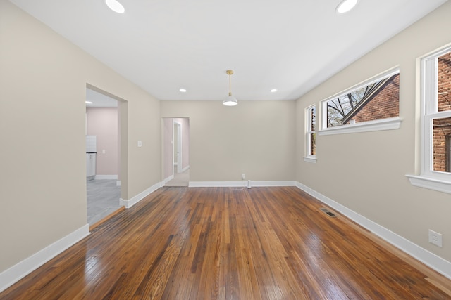 empty room with recessed lighting, hardwood / wood-style flooring, and visible vents