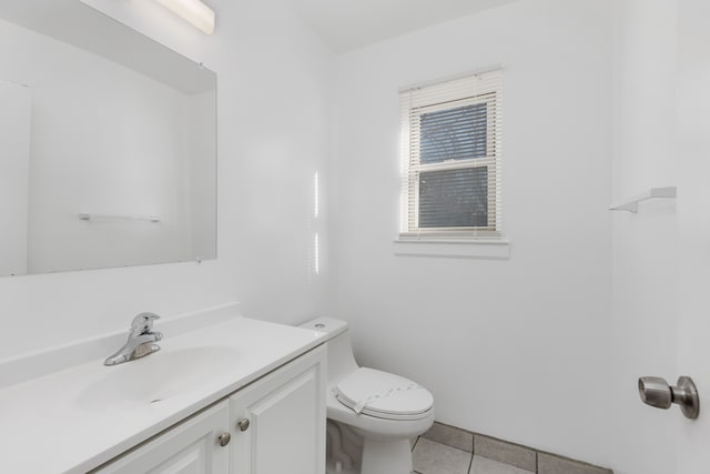 half bath featuring vanity, toilet, and tile patterned flooring