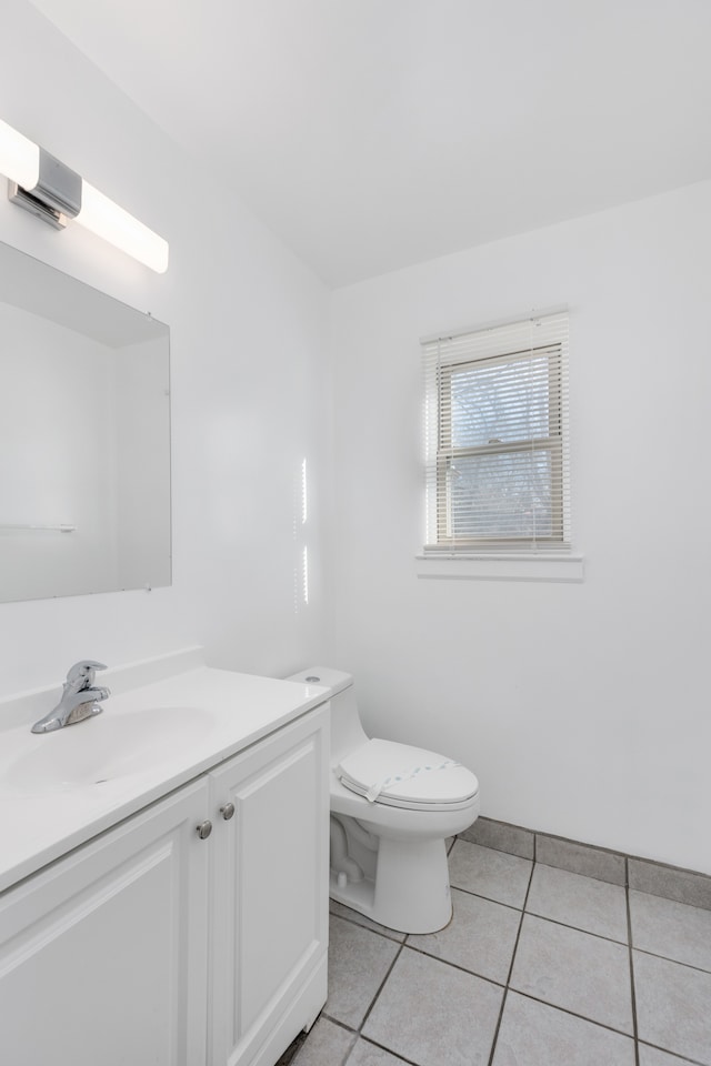 bathroom featuring tile patterned floors, toilet, and vanity