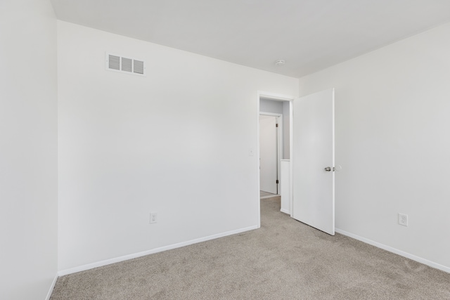 spare room featuring visible vents, baseboards, and carpet floors