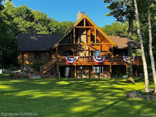 10924 E Grand Lake Rd, Presque Isle, MI 49777 - rear view of house with log exterior, a wooden deck, and a yard