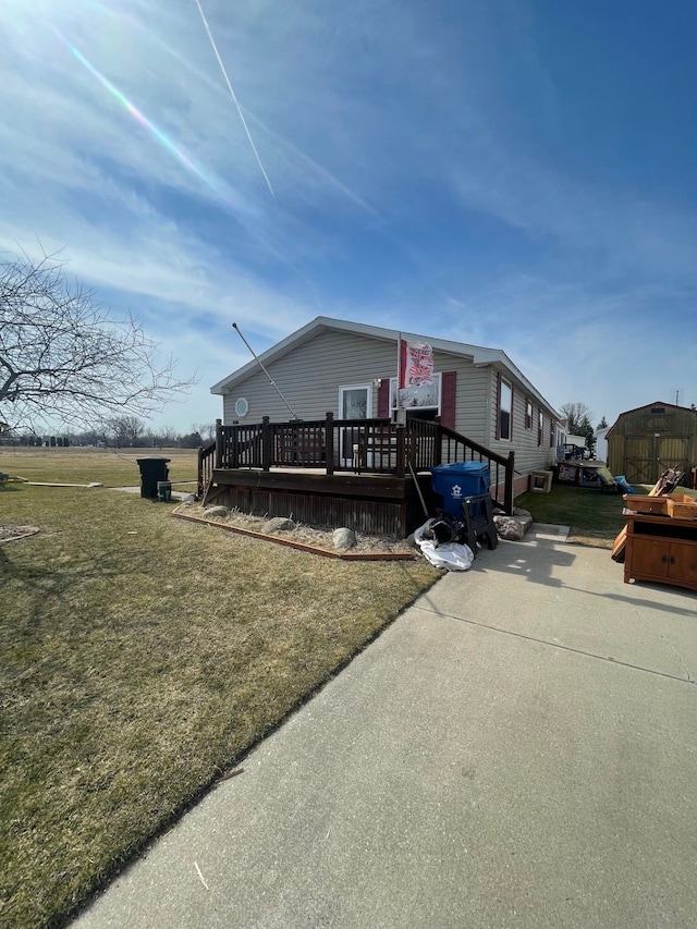 view of front of house with a deck and a front yard