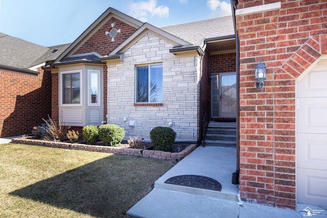 entrance to property with brick siding, stone siding, a shingled roof, and a garage