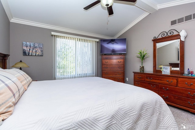 carpeted bedroom featuring visible vents, ceiling fan, crown molding, and vaulted ceiling