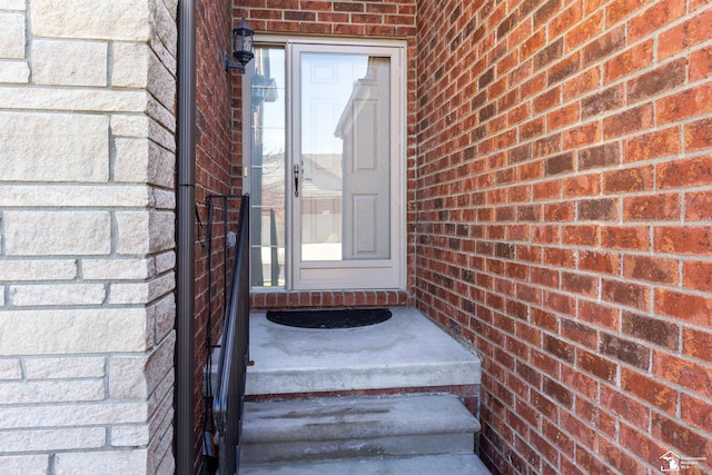 property entrance featuring brick siding