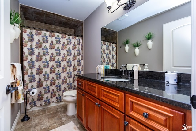 bathroom featuring vanity, toilet, and a shower with curtain