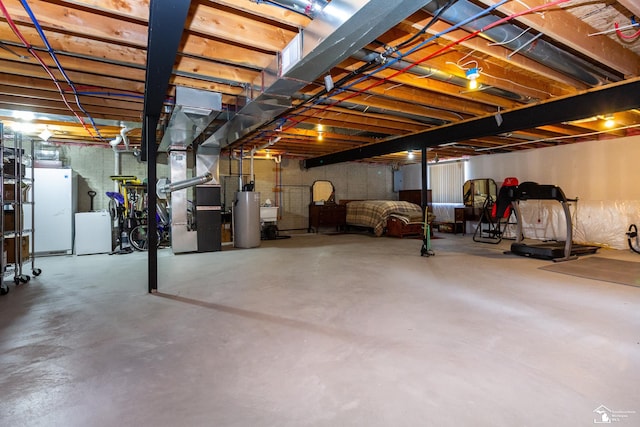 unfinished basement with heating unit, water heater, and freestanding refrigerator