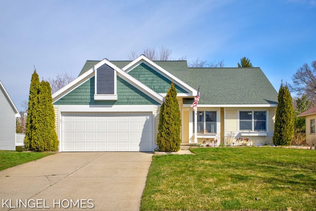 view of front of house featuring driveway, an attached garage, and a front yard