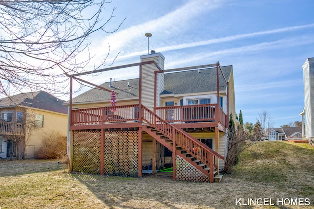 rear view of property featuring stairway, a yard, a shingled roof, a wooden deck, and a chimney