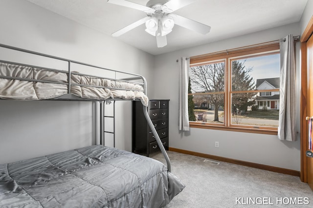 carpeted bedroom with visible vents, ceiling fan, and baseboards