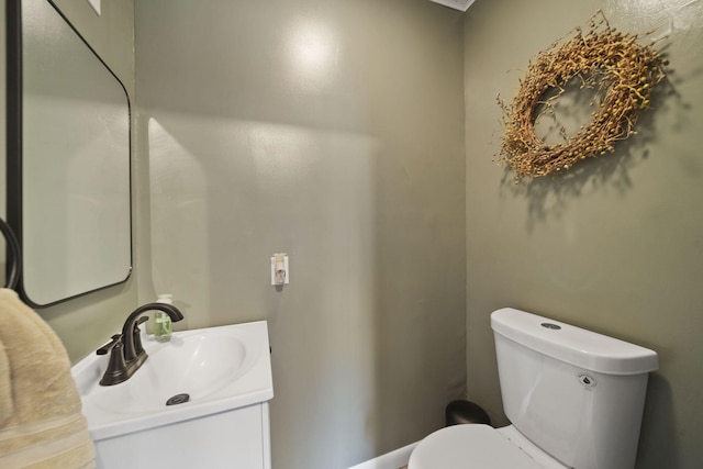 half bathroom featuring toilet and vanity