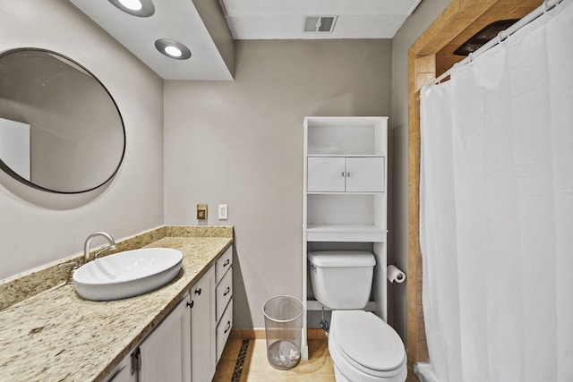 bathroom featuring tile patterned floors, visible vents, toilet, baseboards, and vanity