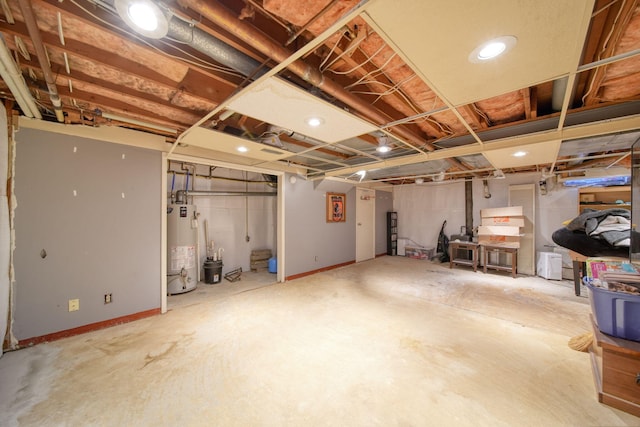 unfinished basement featuring gas water heater