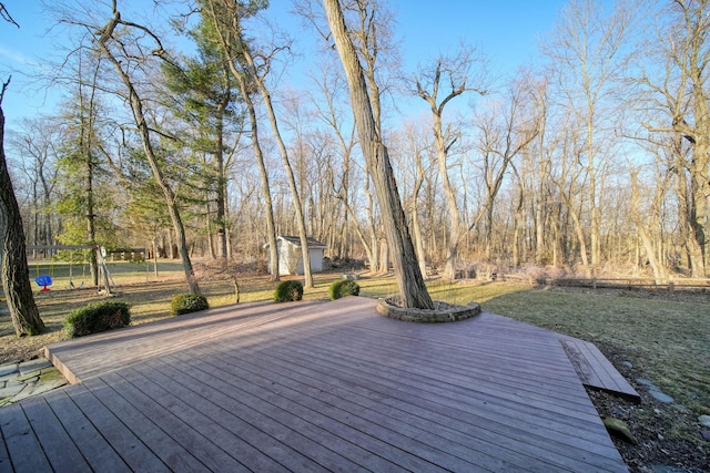 deck featuring an outbuilding and fence