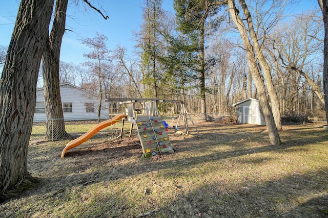 view of play area featuring an outdoor structure, fence, and a shed