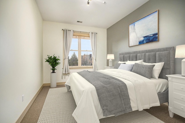 carpeted bedroom featuring visible vents and baseboards