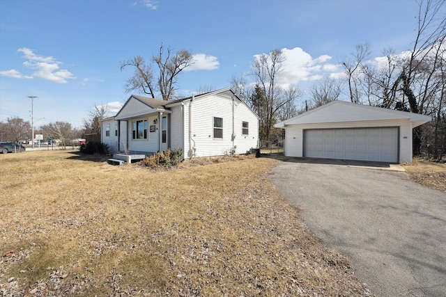 view of front of house with an outbuilding and a detached garage