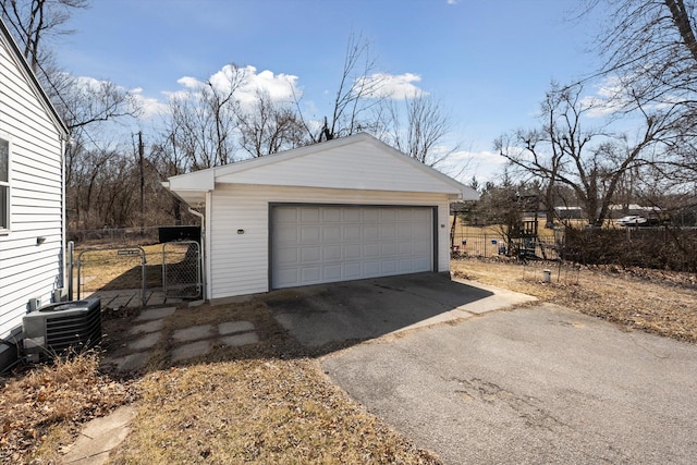 detached garage with central air condition unit and fence