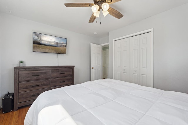 bedroom with wood finished floors, a closet, and ceiling fan