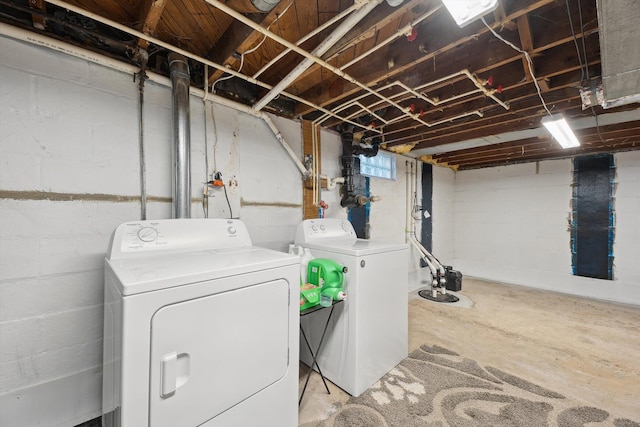 laundry room featuring separate washer and dryer and laundry area