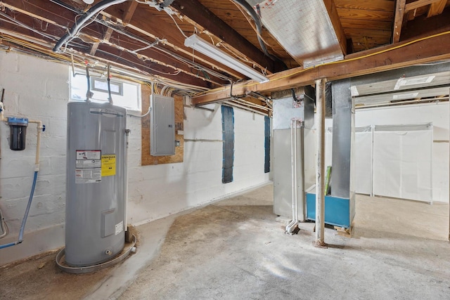 basement featuring electric panel and water heater