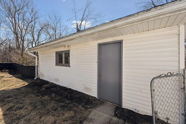 entrance to property featuring fence