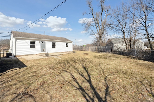 rear view of property with a patio, central AC, a lawn, and a fenced backyard