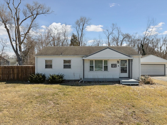 ranch-style house featuring a garage, an outdoor structure, a front lawn, and fence