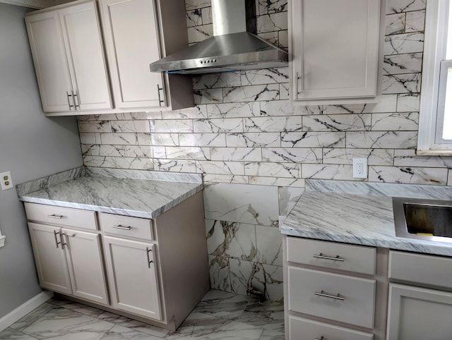 870 Capitol Ave, Lincoln Park, MI 48146 - kitchen featuring wall chimney range hood, light marble finish floors, tasteful backsplash, and light stone counters