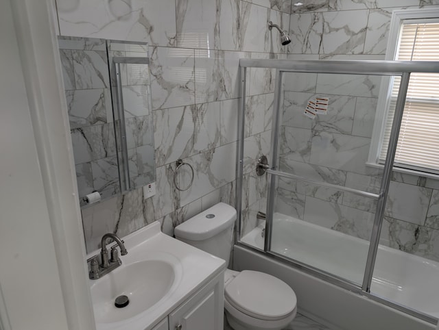 870 Capitol Ave, Lincoln Park, MI 48146 - full bath with shower / bath combination with glass door, vanity, toilet, and tile walls