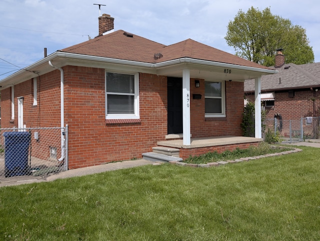 870 Capitol Ave, Lincoln Park, MI 48146 - back of property featuring brick siding, a chimney, a porch, and a shingled roof