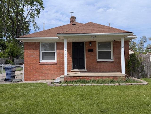 870 Capitol Ave, Lincoln Park, MI 48146 - rear view of property featuring a chimney, a shingled roof, brick siding, and covered porch