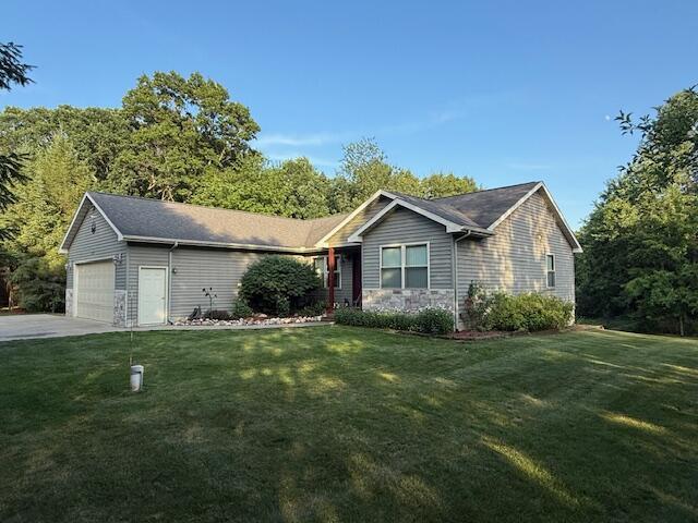 1357 W M-20, New Era, MI 49446 - ranch-style home featuring an attached garage, a front lawn, and concrete driveway