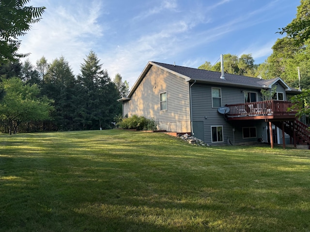 1357 W M-20, New Era, MI 49446 - rear view of house with a wooden deck, a yard, and stairway