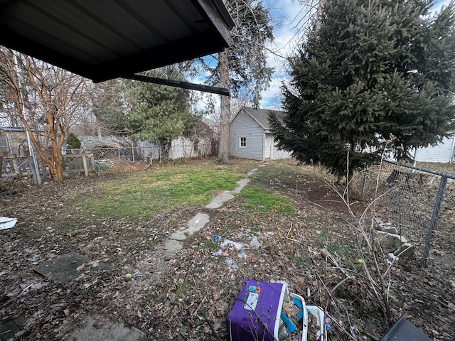 view of yard featuring an outdoor structure and fence